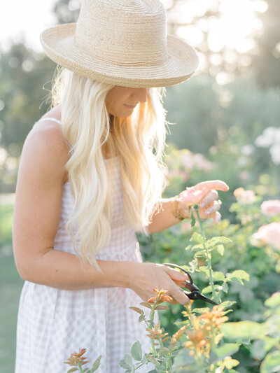 woman in a garden picking flowers