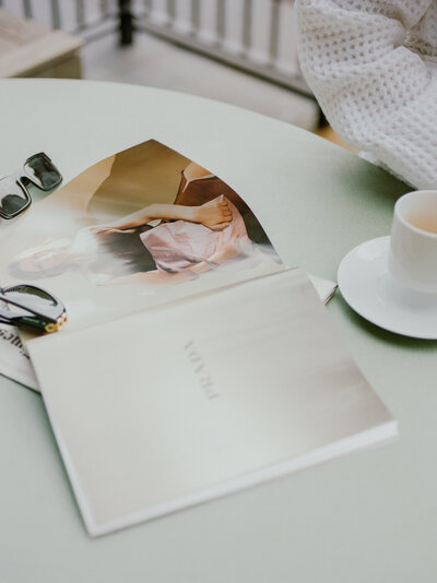 Vogue magazine, coffee, and sunglasses on a green table on the balcony at Shinola Hotel in Detroit, Michigan
