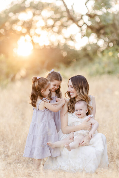 Mom and daughter hugging each other during their family photo session
