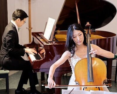 bride and groom playing classical music on cello and piano