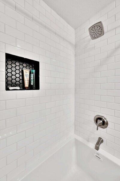 Stand up shower in the bathroom of this one-bedroom, one-bathroom luxury condo in the historic Behrens building in downtown Waco, TX.