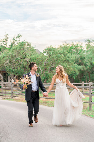 Groom running with his bride in South Austin Texas.