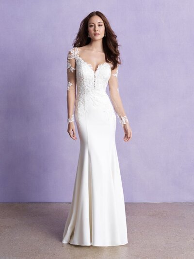 There's a beautiful contrast between the rich crepe and delicate illusion detailing on this long sleeved sheath gown.