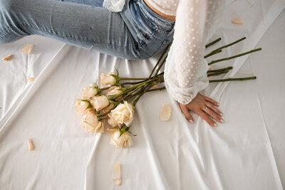 woman sitting next to flowers