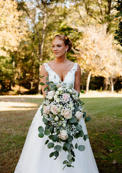 bride holding bouquet outside of venue
