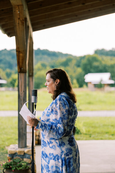 The bride's mother gives a speech during the wedding reception at the barn of Paint Rock Farm in North Carolina, by photographer My Sun and Stars Co.