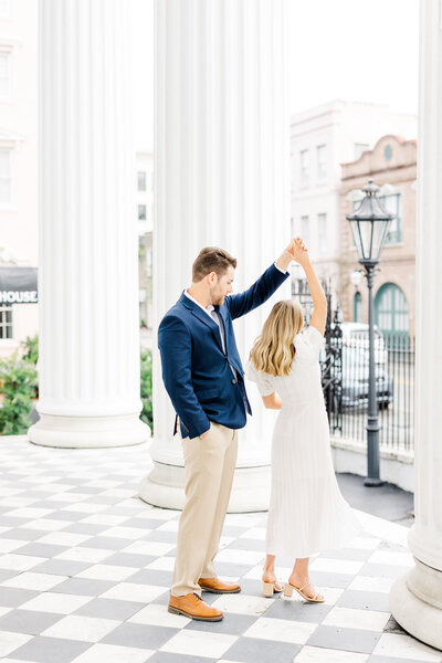 guy spinning girl during engagement session at hibernian hall