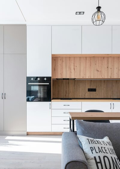 Clean home with timber floors, natural linen on bed and rattan rug