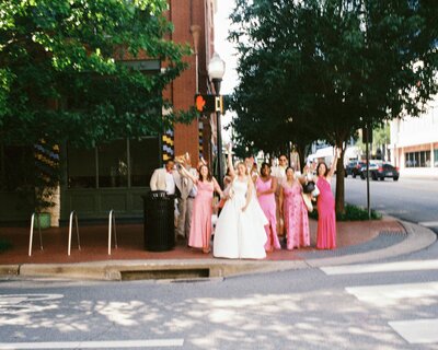 Wedding guests holding up a bride at the reception