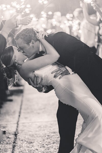 Bride and groom kissing  during wedding exit