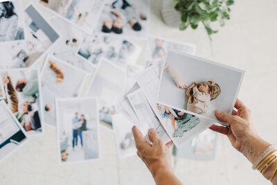 Natasha Sewell lying down on photo prints by her