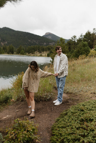 Tyler and Lily explore the stunning Rocky Mountain National park for their anniversary couples session. The young and in love couple take a walk along a path next to Lily Lake while enjoying quality time with each other.