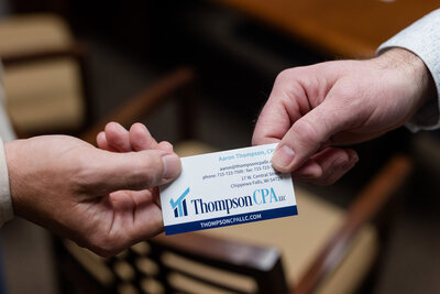 Aaron handing his business card to a client