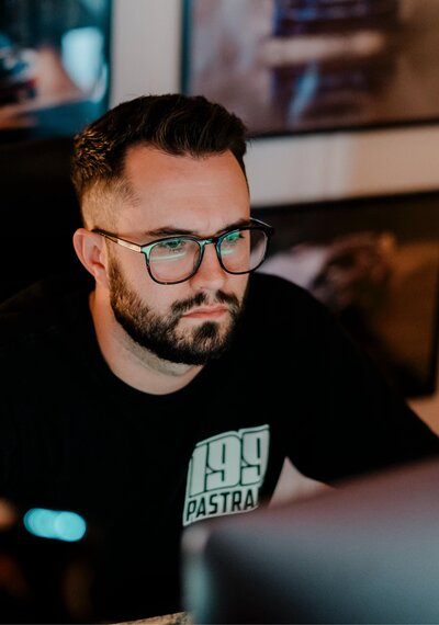 Video producer, Chris Costello, editing footage on a computer during post-production