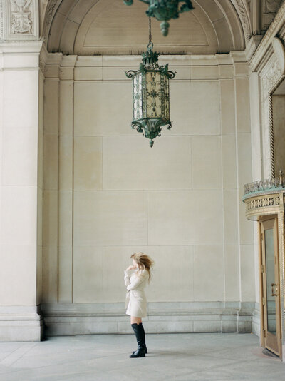 woman, hair movement, Detroit architecture with gilded door details, ornate, simple, film wedding photographer