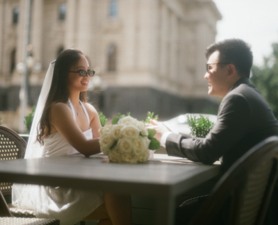 Couple sitting in the city after wedding ceremony shot on 120 film