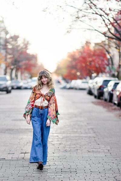 Girl in bohemian outfit walking down a  brick road