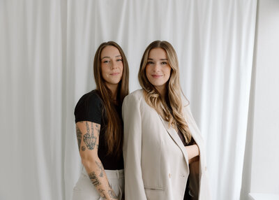 Two women standing and smiling