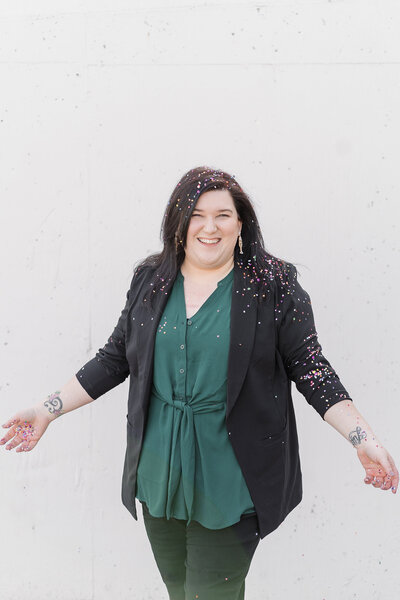 a lgbtq sacramento wedding photographer throws confettit for her branding photos