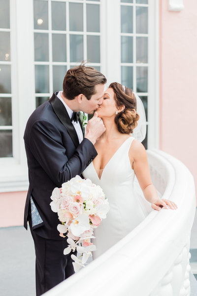bride and groom kissing at destination wedding at don cesar hotel in st petersburg florida by costola photography