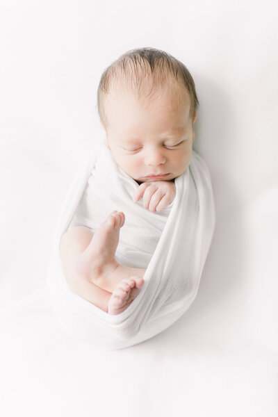all white simple wrapped newborn photo.