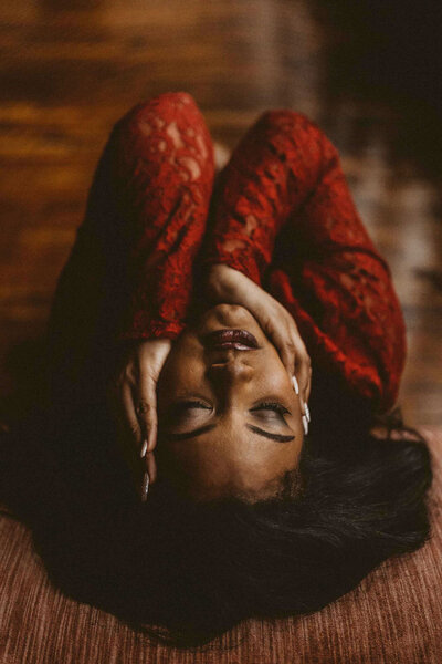 woman on a red shirt laying on the floor