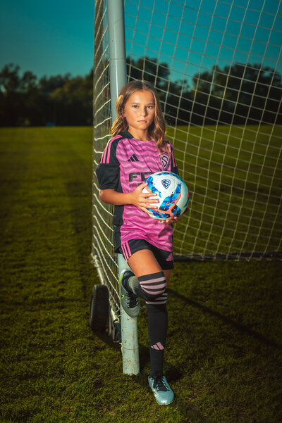 Soccer player posing with ball