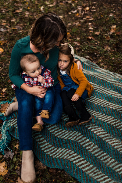 Family photography session of a mom with two young children.