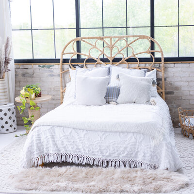 Close up of a styled bed with white bedspread - photoshoot location