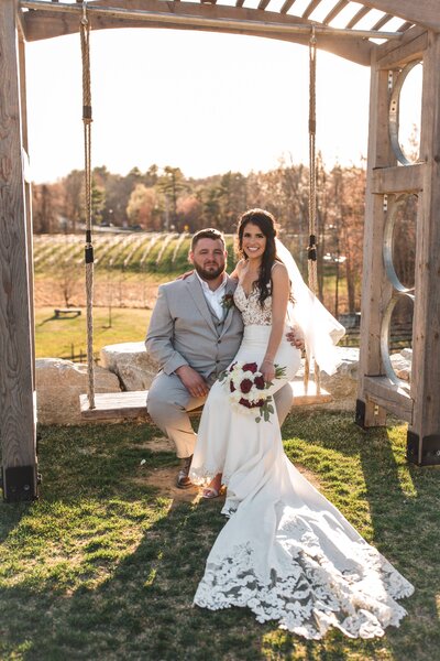 LaBelle Winery - Couple On A Swing With Vineyard as Backdrop For Their Wedding Photo