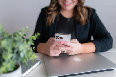 Sarah Hawk, tech educator, holding her iPhone