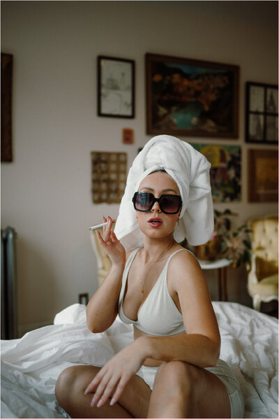 woman-holding-ciggerette-in-bed-with-towel-on-her-head