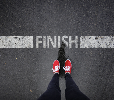 Girl with red shoes standing at finish line