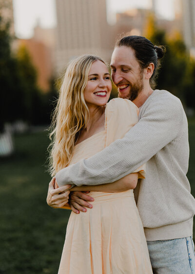 Side profile photo of a girl with blonde windswept hair, resting her forehead against her husband's face