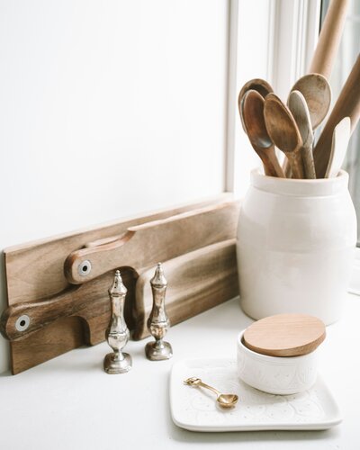 Kitchen countertop with spoons and cutting boards. 