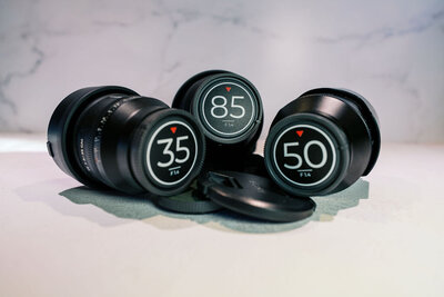 Collection of Sony prime lenses including 35mm, 50mm, and 85mm f/1.4, used by Joseph Mayden for sharp, cinematic portraits and professional photo/video work.