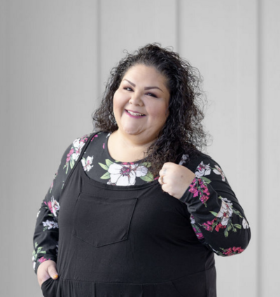 woman in floral and black smiling at camera