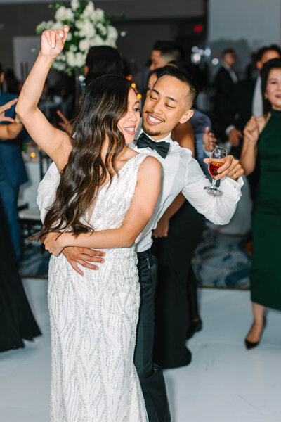 Flash photo of bride and groom dancing together with arms around each other