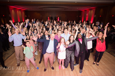 Excited guests of all ages cheering and dancing at a Chicago Bar Mitzvah with Charizma DJ and emcee