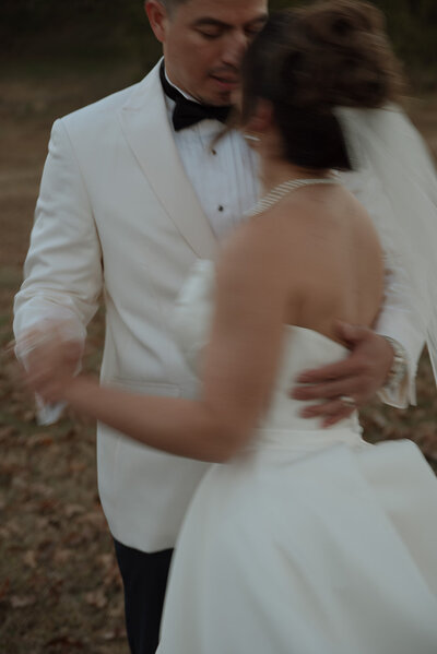 Bride and Groom in White Tuxedo and Maggie Louise Wedding Dress