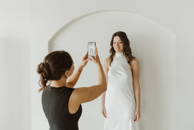 Makeup artist taking photo of her brides makeup look.