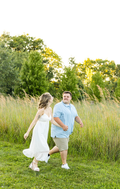 man and woman running through field