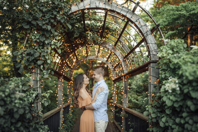 Sayen House & Gardens | Couple under string lights during summer engagement photo | Hamilton Township, New Jersey