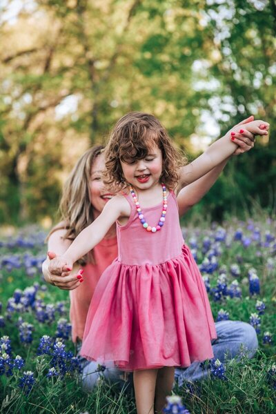 Ali and her daughter in a field of flowers