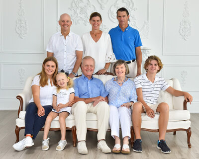 multi-generational family portrait in white bright studio