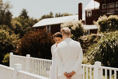 Picture of bride’s standing together facing each other, Unique Melody Events & Design (New England Wedding Planners) were part of this wedding.