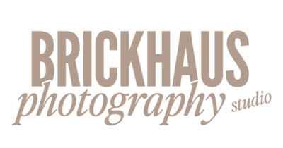 A beige logo with bold text that says "BrickHaus" and an elegant italic typeface that says "photography studio"
