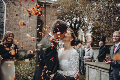 Young Gen Z bride and groom kissing after their confetti shot in Deal, Kent