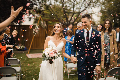 confetti thrown by guests  at calgary backyard wedding