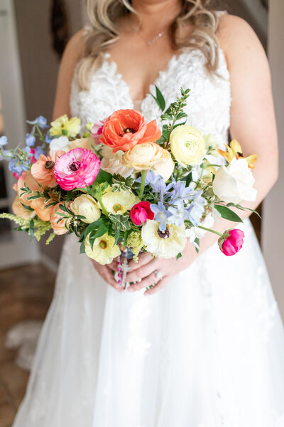 Rustic bridal bouquet featuring sunflowers, white roses, and eucalyptus leaves by Leigh Florist, perfect for a summer barn wedding.